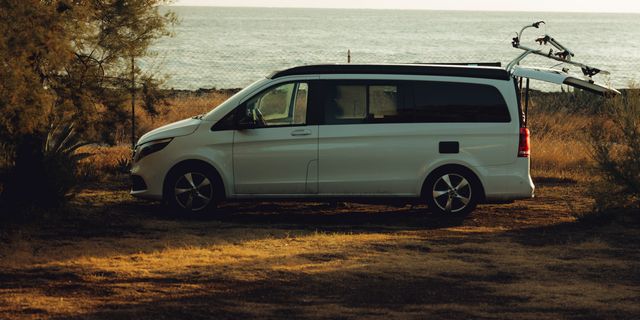 Ein Off Marco Polo Camper steht vor dem Meer auf dem Strand im Sommer