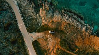 Drone shot of camper van at the coast