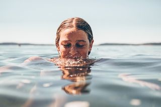 A woman swims in the lake.