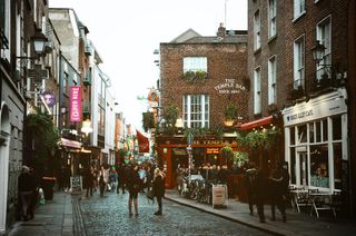 small street with houses on the side and cafés