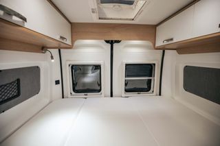 The spacious rear bed of the Mooveo travel van