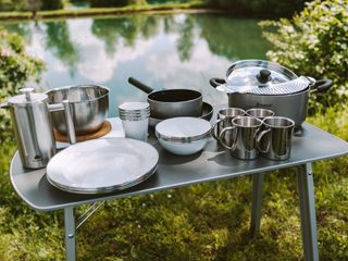 Campingtisch mit Küchenutensilien.